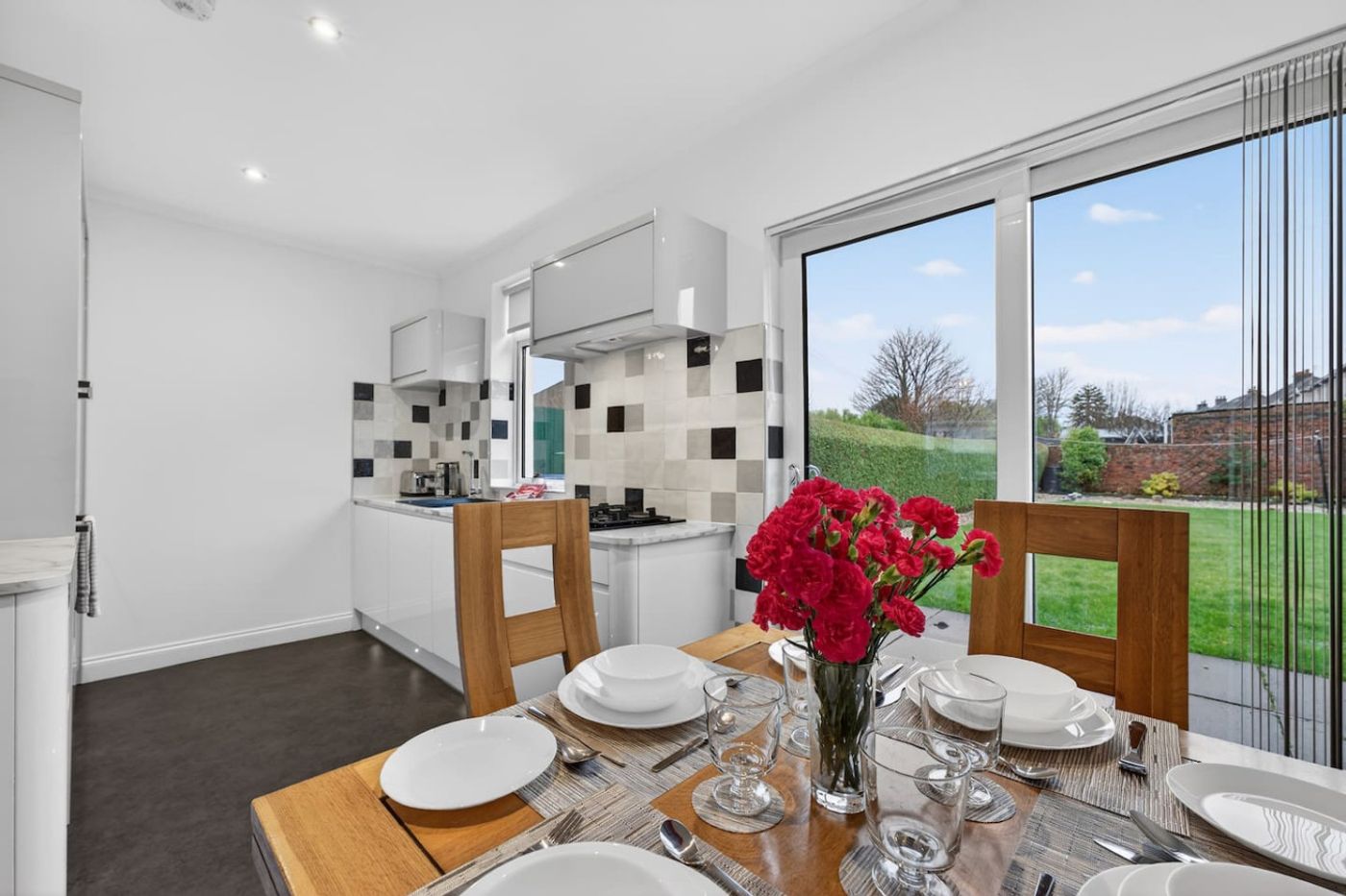 Kitchen and dining table, with doors out to the garden.